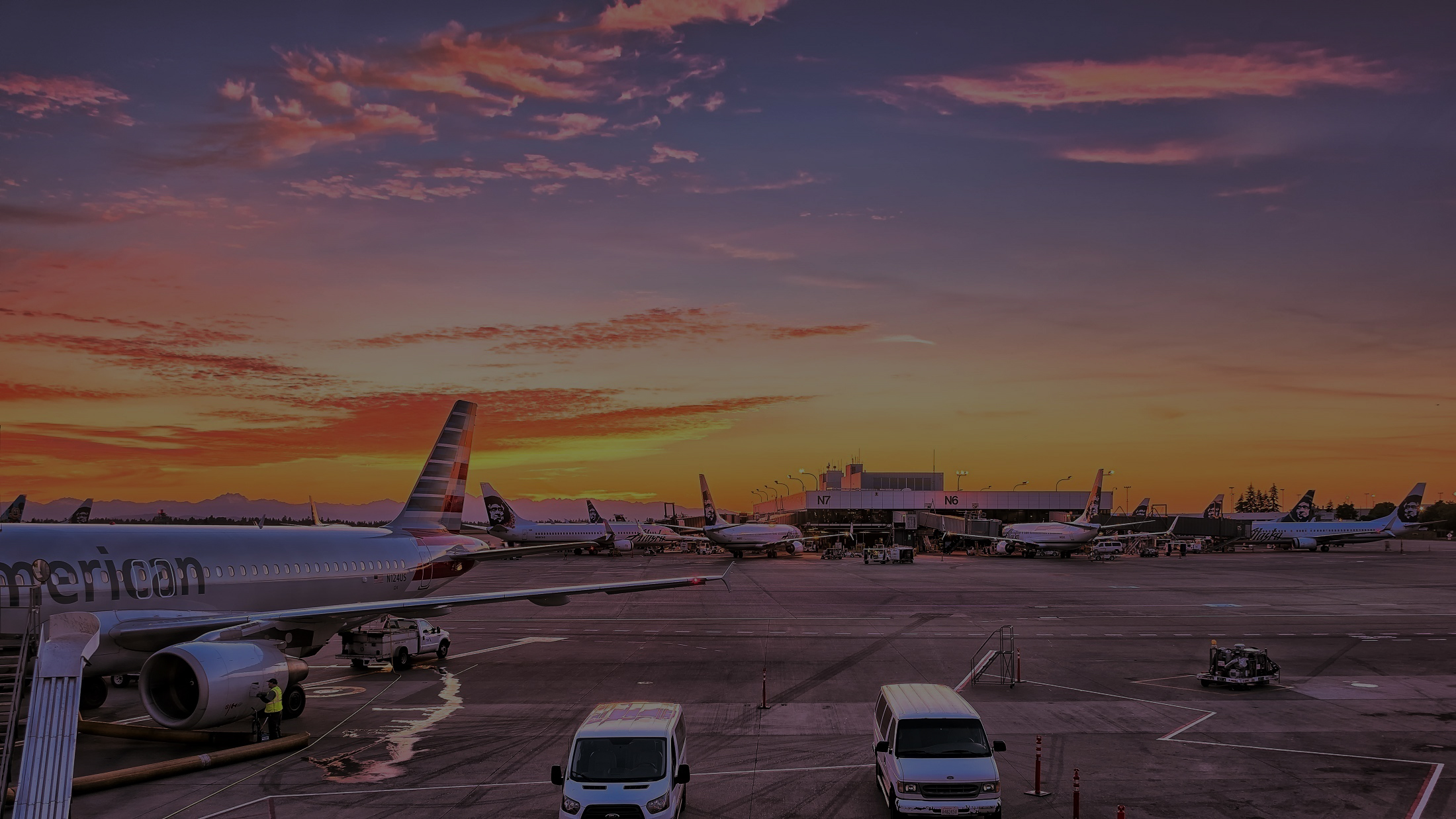 Aircraft parked at an airport at sunset